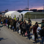 Spanish police move migrants from the beaches of Ceuta to a temporary tented site